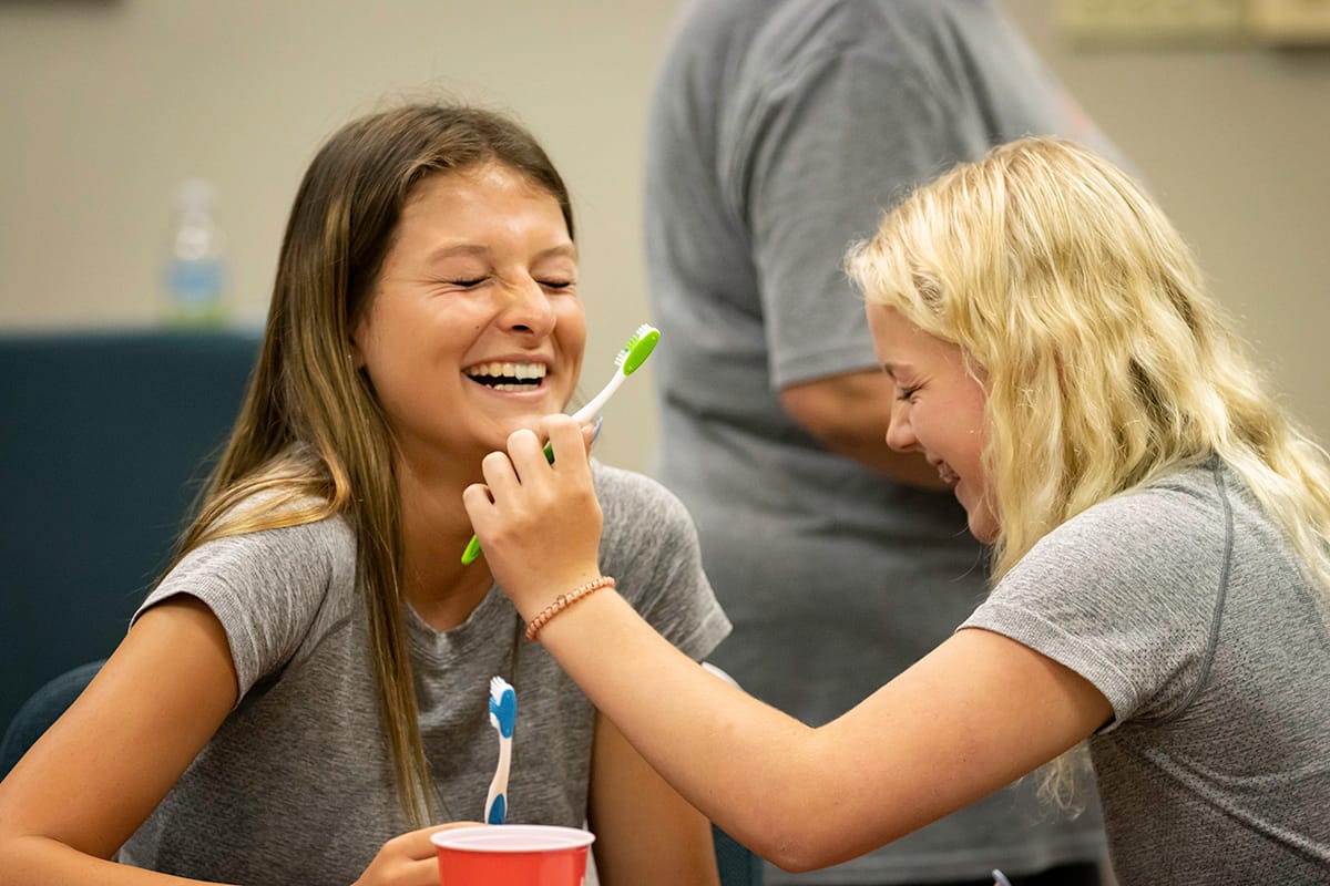 kids brush each others teeth during nursing camp