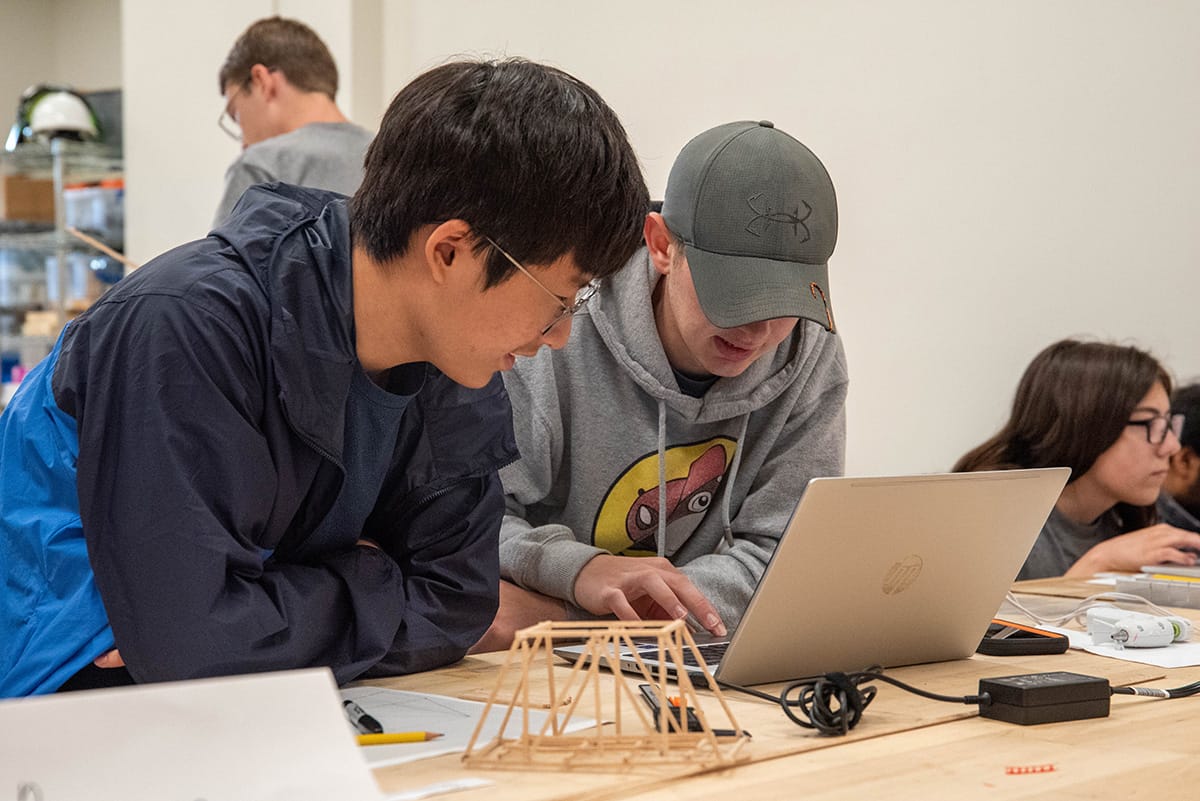 kids build bridges from popsicle sticks during engineering camp 
