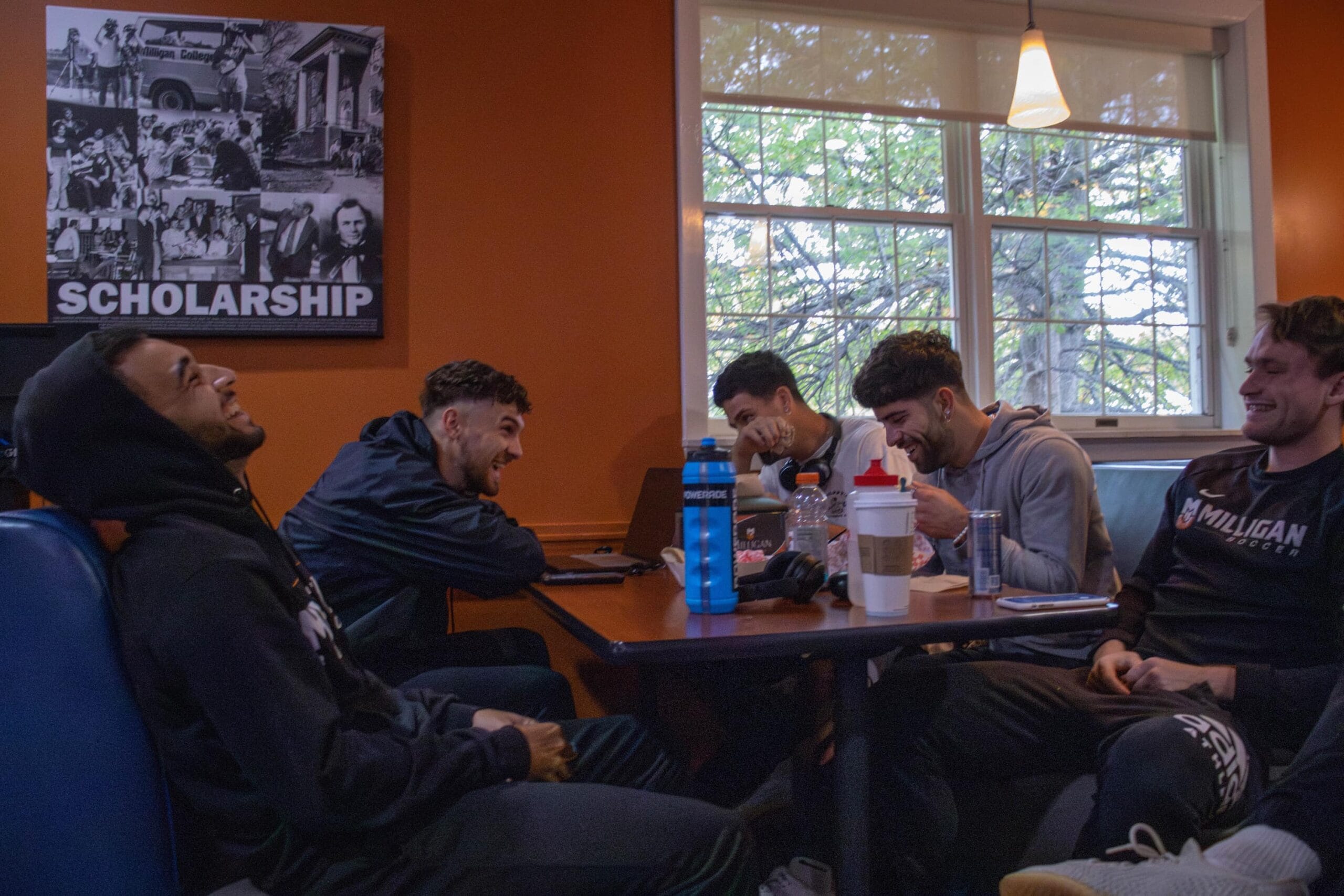 five male students at the grill eating