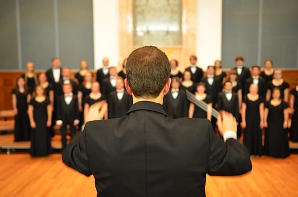 a choir conductor in front of the choir